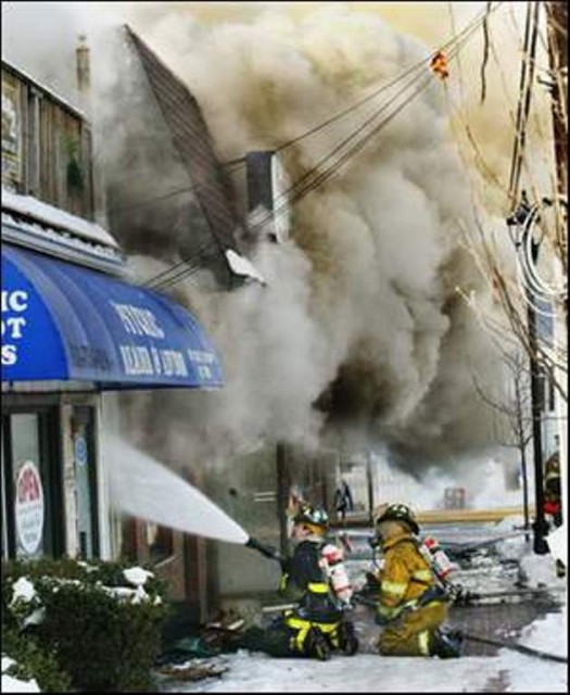 FF/EMT Bennett and FF Silveira man the 2 1/2&quot; at a strip mall fire on New Brunswick Avenue.